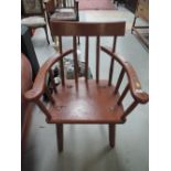 A rustic look farm house style smokers or carvers arm chair