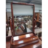 A Victorian mahogany toilet/swing mirror having shaped supports and platform base