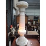 A marble or similar heavy carved stone jardinnierre stand with integral light in a Roman column