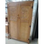 An early 20th Century golden limed oak bedroom suite comprising wardrobe, drawers, dressing table