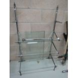 A glass shelved display shelf and similar rack