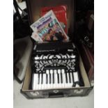A Delicia piano accordion, with hard case and sheet music