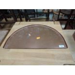 A semi-circular copper tray
