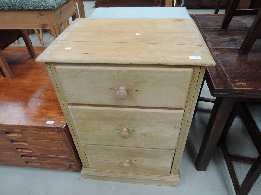 A stripped pine three drawer chest