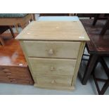 A stripped pine three drawer chest
