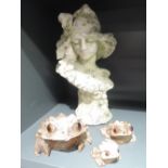 A bust and three plaster frogs