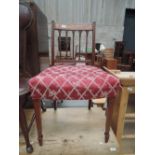 An early 19th century mahogany dining chair having slat back with later overstuffed seat and tapered