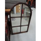 An arch window style wall mirror