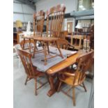 A modern stained frame dining table and six (four plus two) chairs