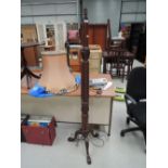 An early 20th century mahogany torchere/standard lamp having wrythen column and carved triple