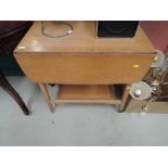 A vintage golden oak tea trolley table