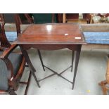 An early 20th century mahogany oak table, on slender tapered legs