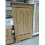 A traditional stripped pine wardrobe