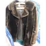 Ladies vintage sheepskin coat in brown. Some wear to lining.