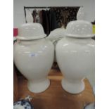 A pair of large white glaze urns