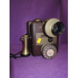 A shop or factory telephone or similar telephone, with brass fitments bearing military foot stamp.