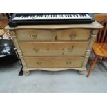 A stripped pine chest of two over two drawers