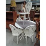 A modern white painted dining table and 4 wheelback chairs