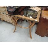 A bent wood and glass top table