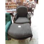 A large classical style arm chair and footstool