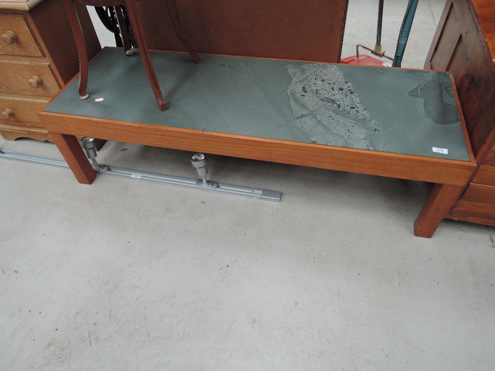 A vintage teak and slate coffee table