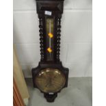 An early 21st century dark oak cased barometer by Greenwood & Sons