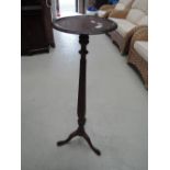 An early 20th century mahogany torchere/jardiniere stand having reeded column and triple splay legs