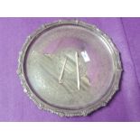 A silver plated circular salver having raised rim with scallop shell and gadrooned decoration,