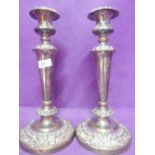A pair of Sheffield plate weighted candle sticks of classical form having removable sconces, tapered
