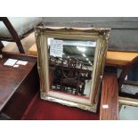 A small gilt frame wall mirror