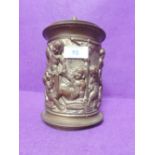 A brass tobacco jar or tea caddy, with pine cone knop and figural decoration