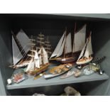 A selection of model ships and boats, on stands and in bottles