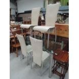 A modern glass extending table and 4 leatherette dining chairs