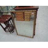 A gilt and plaster effect wall mirror