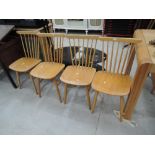 A set of four Ercol style beech spindle back chairs