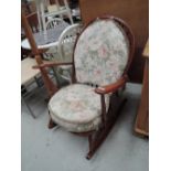 An Ercol style spindle back rocker, dark red stain