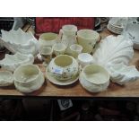 A selection of 20th century Belleek and Coalport porcelain trinkets including pots, jugs and egg