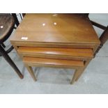 A vintage teak style nest of tables