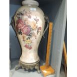 A tall floor vase with elephant handles and measuring stick
