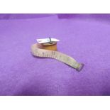 A vintage treen miniature sewing tape measure