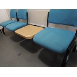 A three seat bench, cinema style, in blue with table