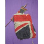 Two GB vintage Union flags, one on staff and one with bullet holes