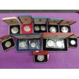 A collection of silver proof coins in cases, including GB, Iceland, Seychelles, ten in total