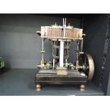 A very well engineered scratch built vertical twin cylinder live steam engine mounted on wooden