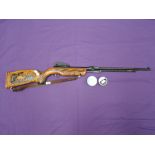 A B.S.A. .22 Tornado under lever air rifle, stock heavily carved decoration, plus two tins of