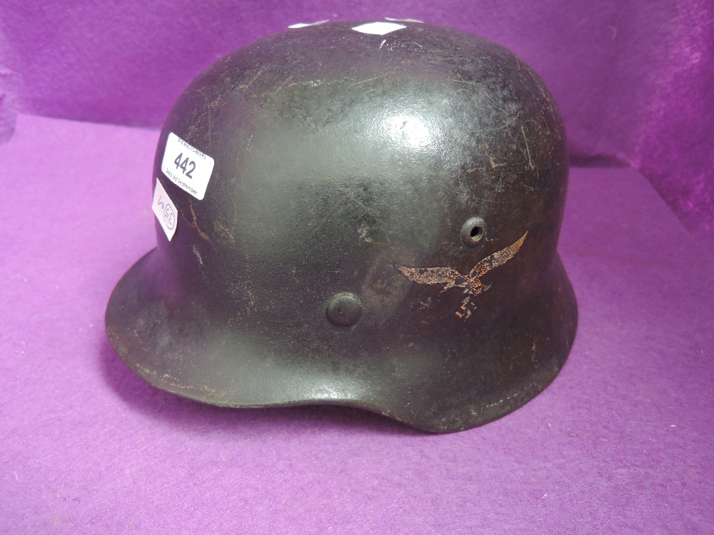 A World War II German Luftwaffe helmet with Luftwaffe Eagle and National Colours Shield decals on