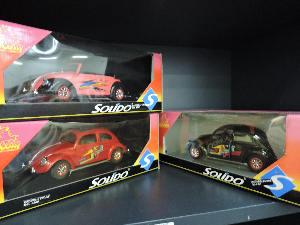 Three Solido Custom 1:18 scale diecast Beetle cars having reference numbers 8302, 8304 & 8306, all