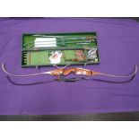 A collection of archery equipment including two bows, box of arrows, bow strings, guards and