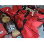 A selection of fishing equipment and tackle in two red bags