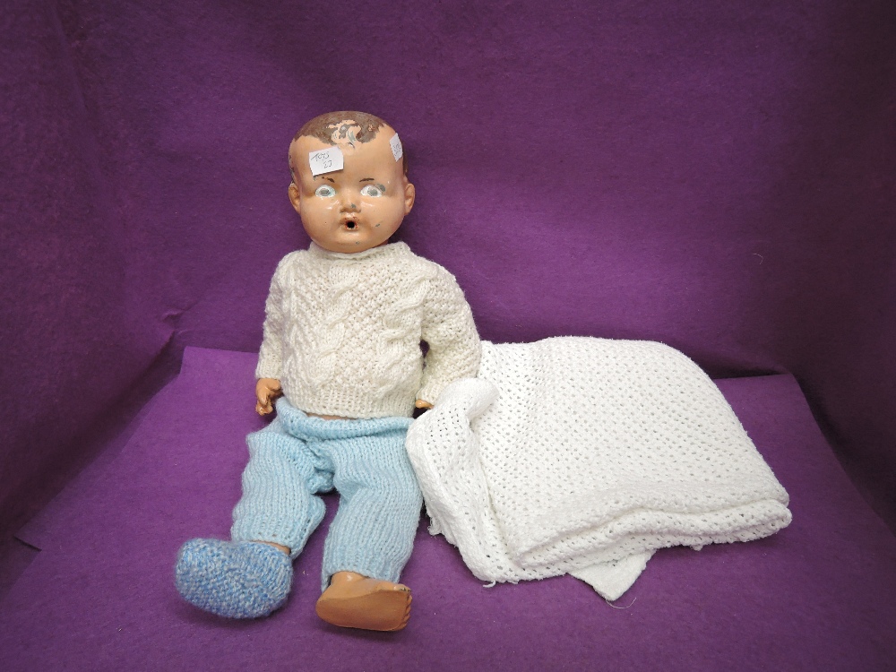 A English style 1950's composition doll having painted eyes, open mouth and jointed body, wearing